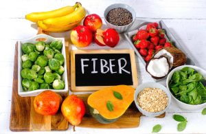 A variety of foods rich in dietary fiber for healthy digestion, including fruits, vegetables, whole grains, and legumes.